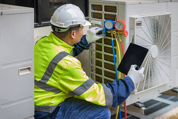 Professional Hvac technician working in Raynham Center, MA